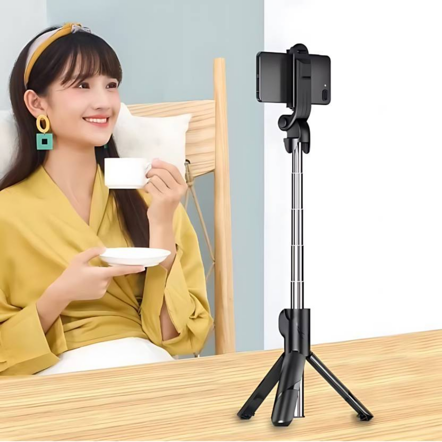 Stainless steel selfie stick with tripod for hands-free video recording.

